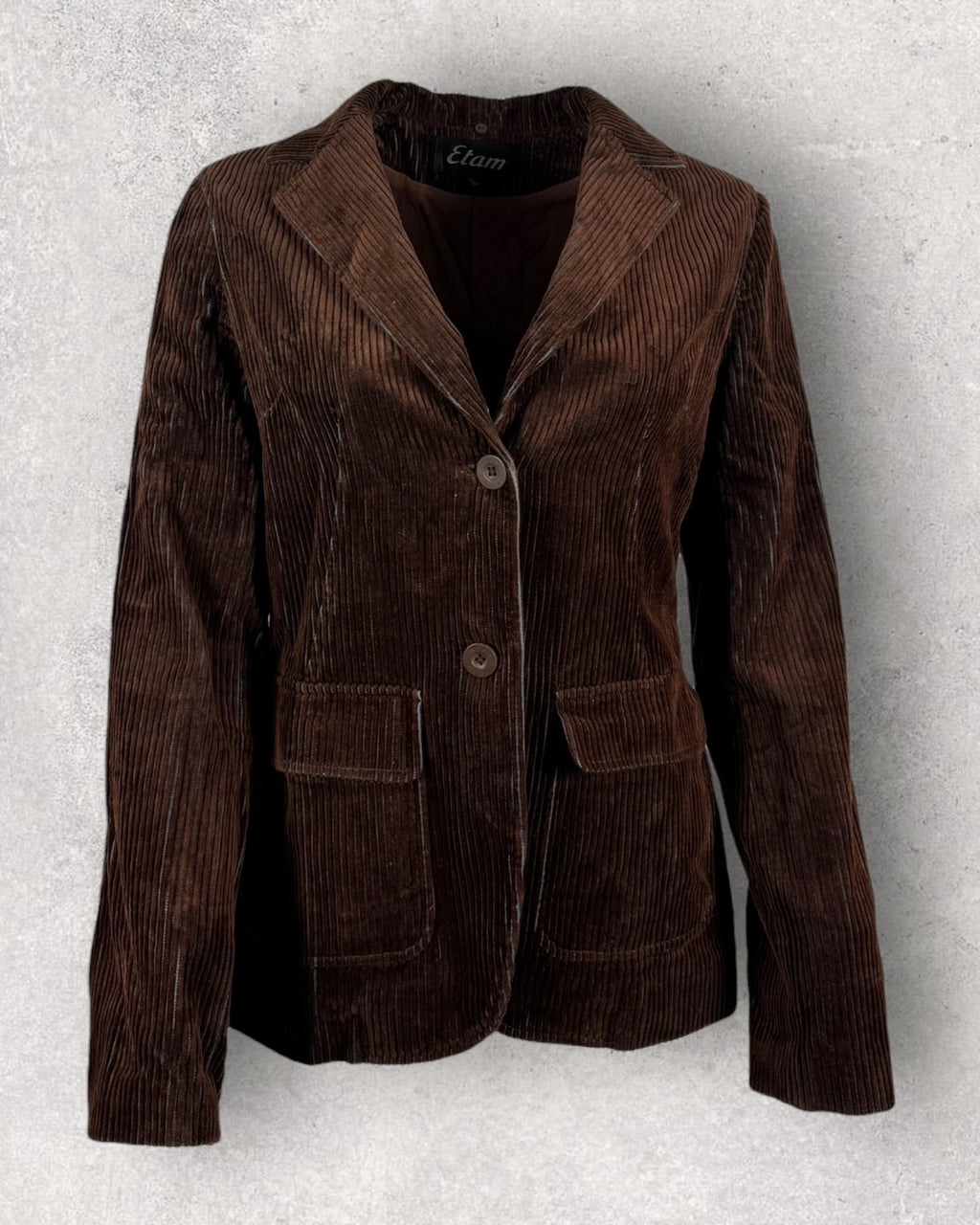Brown corduroy jacket on a textured gray background