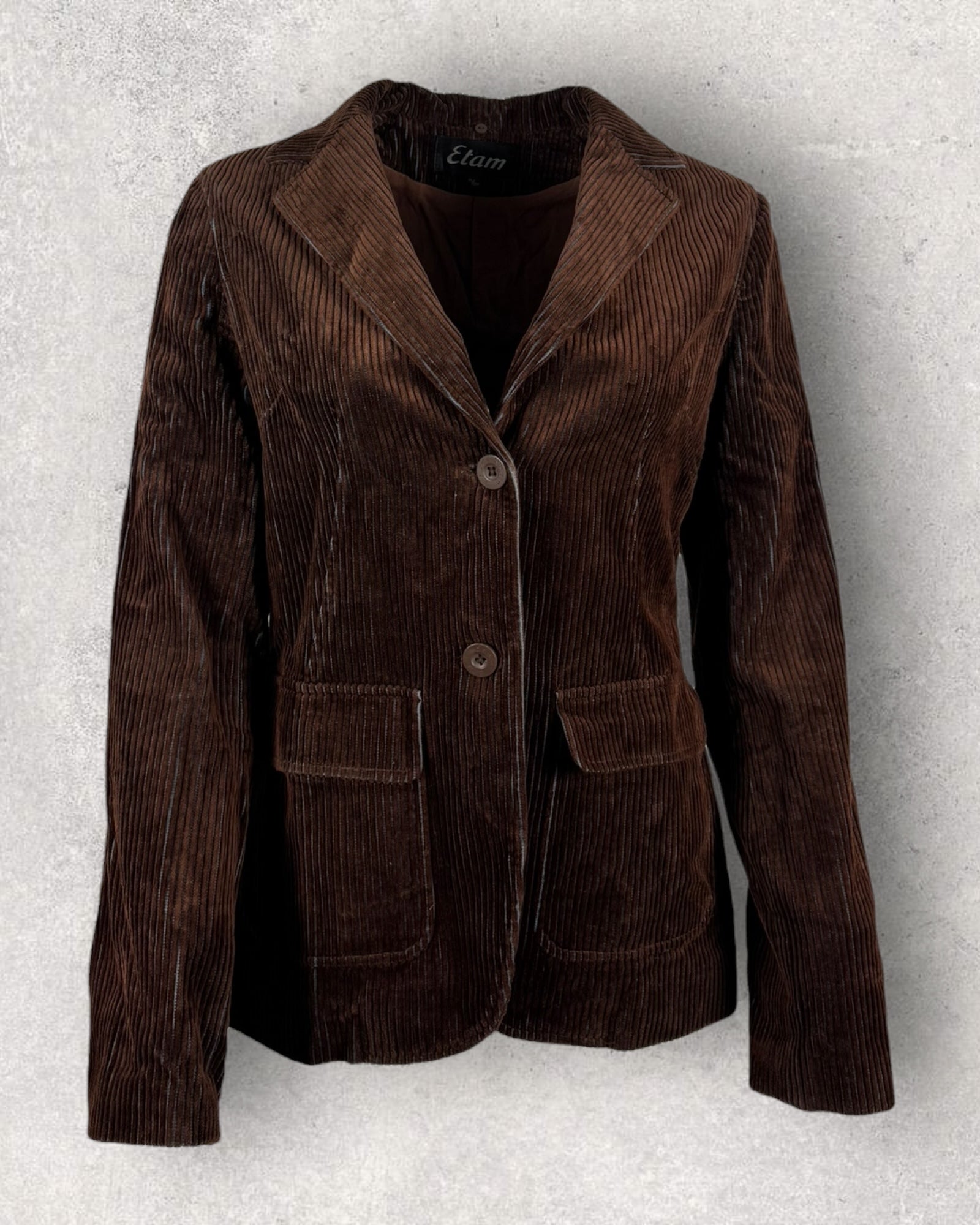 Brown corduroy jacket on a textured gray background
